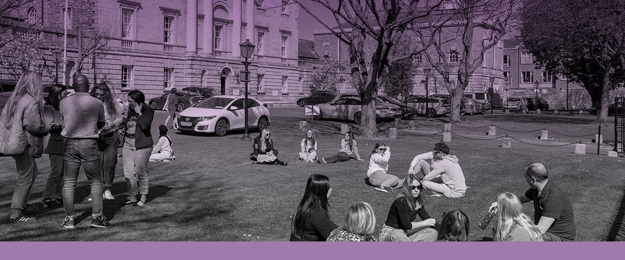 Mixed groups of trainee solicitors talking on the green at Blackhall Place