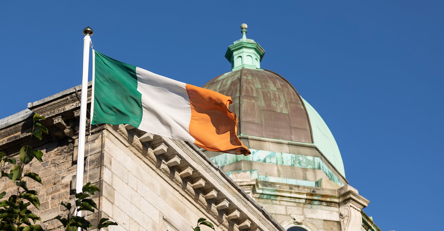 The Irish flag at Blackhall Place with a classical building cupola in the background