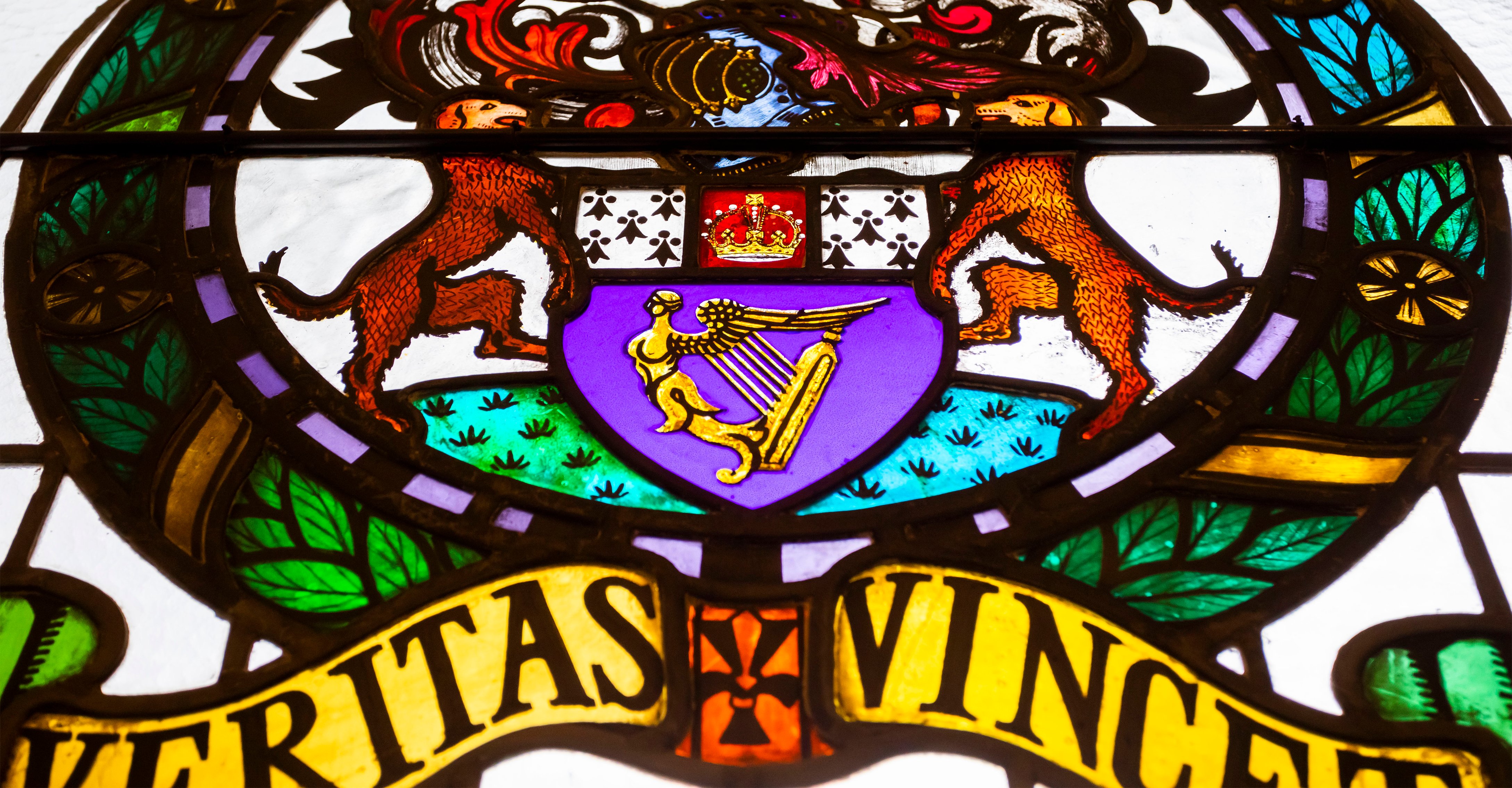 A stained glass window with the Law Society motto Veritas vincet, meaning 'truth will triumph'