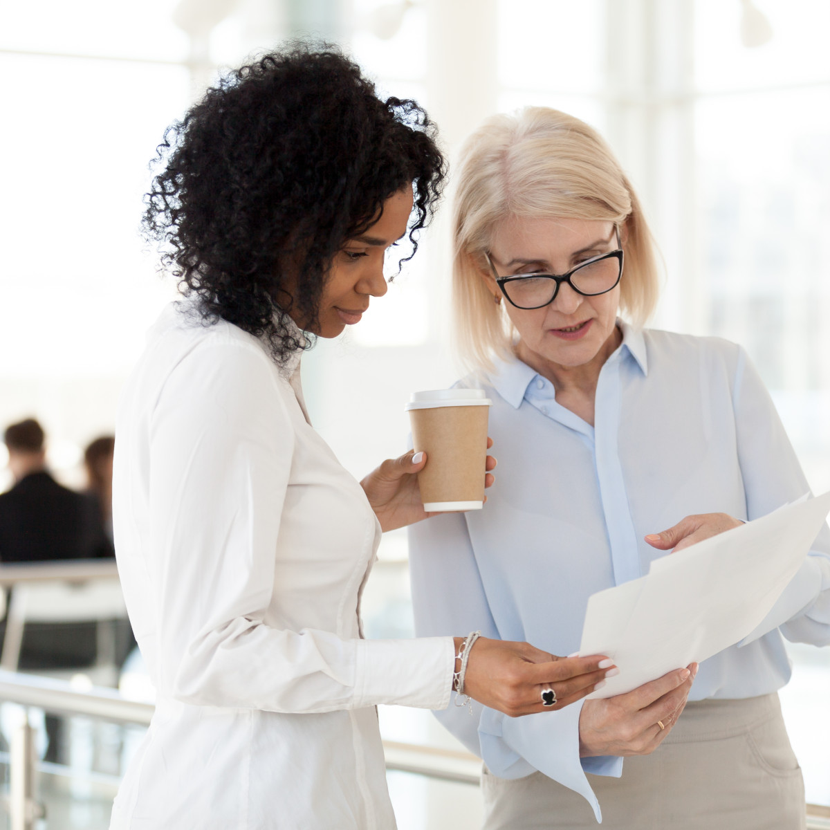 A senior and junior colleague in a legal workplace.