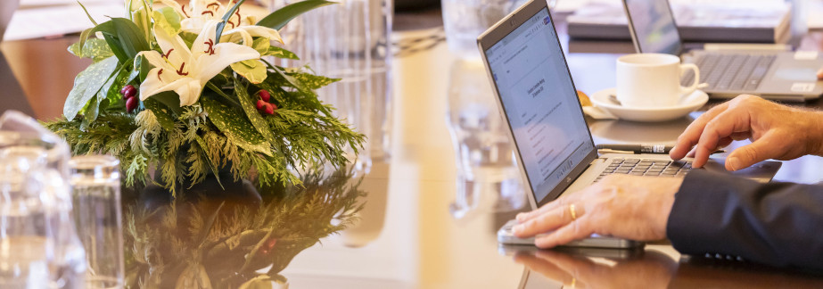 person working with laptop on desk