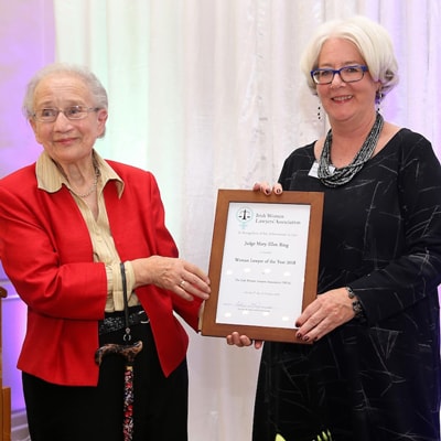 Justice Mary Ellen Ring receives her award from Justice Catherine McGuinness