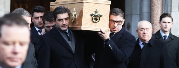 Peter Sutherland’s sons Ian and Shane shoulder their father’s coffin