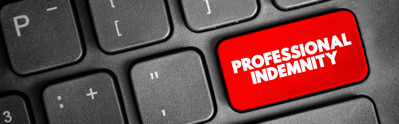 A keyboard showing professional indemnity on the Return key