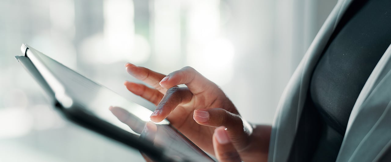 A person reading a website on a tablet computer