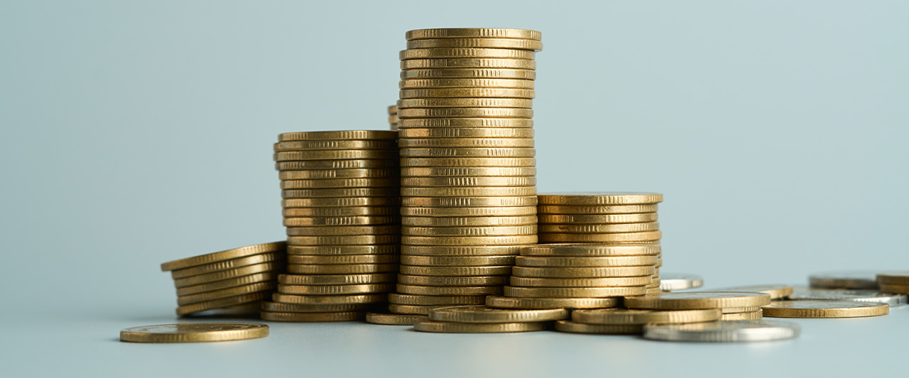A stack of coins against a teal background