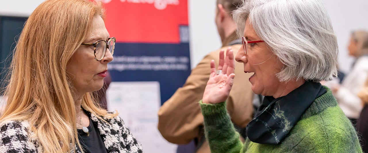 Two solicitors in conversation at a Committee conference