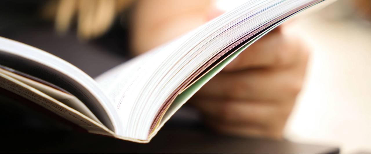 Female hands reading a book in sunlight