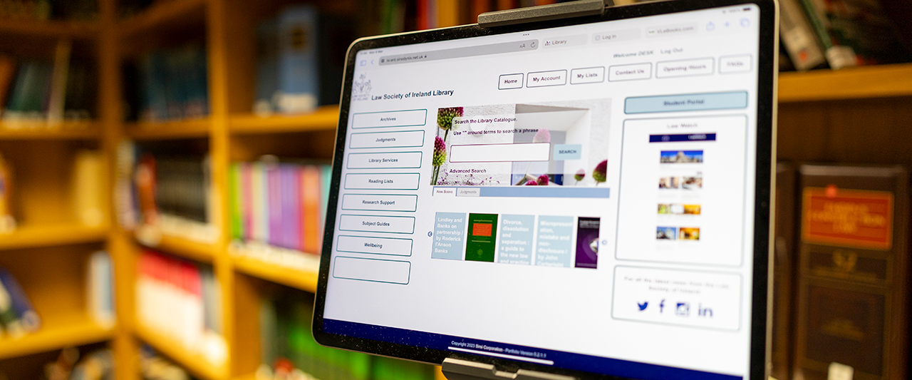 A tablet in the Law Society Library with a bookcase behind it