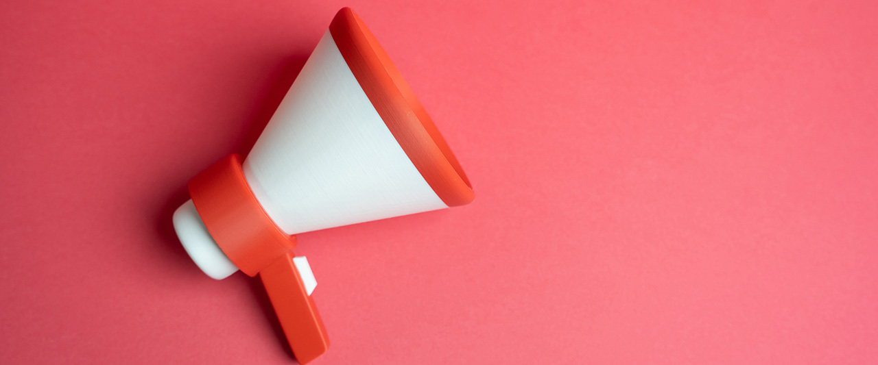 A decorative image of a megaphone against a pink background