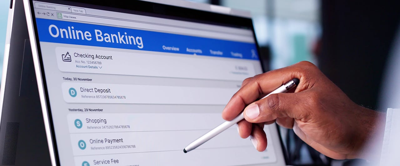 A professional using the online banking app on a tablet