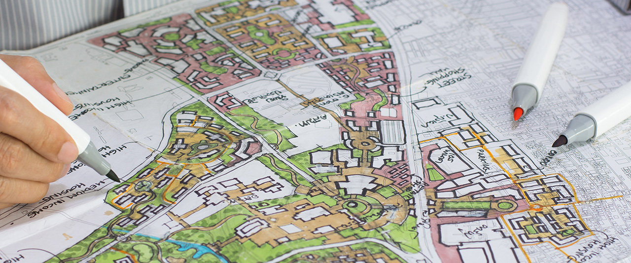 A person scrutinising a map of a planned urban area