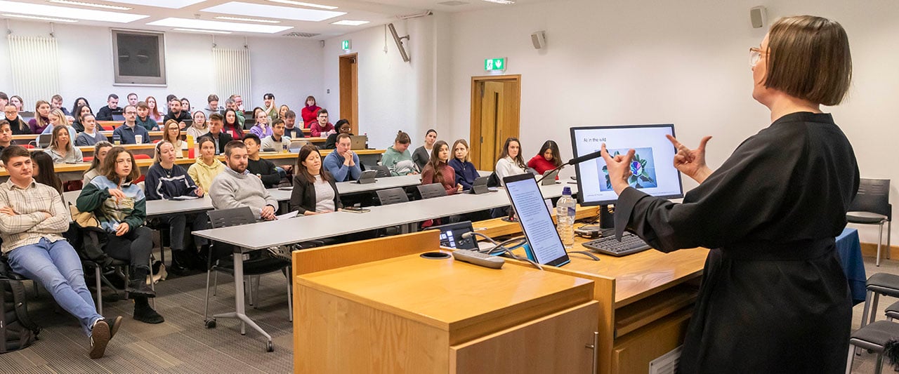 A lecture in progress at Blackhall Place, Dublin. A female speaker is giving a lecture to an engaged audience of trainee solicitors
