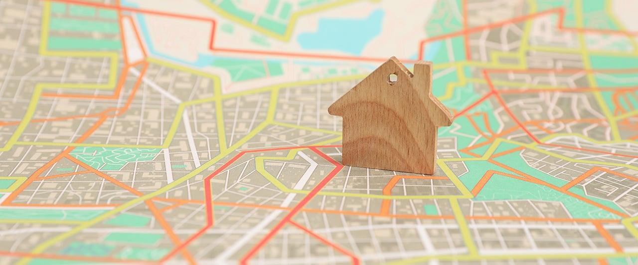 A wooden figure of property on a stree map