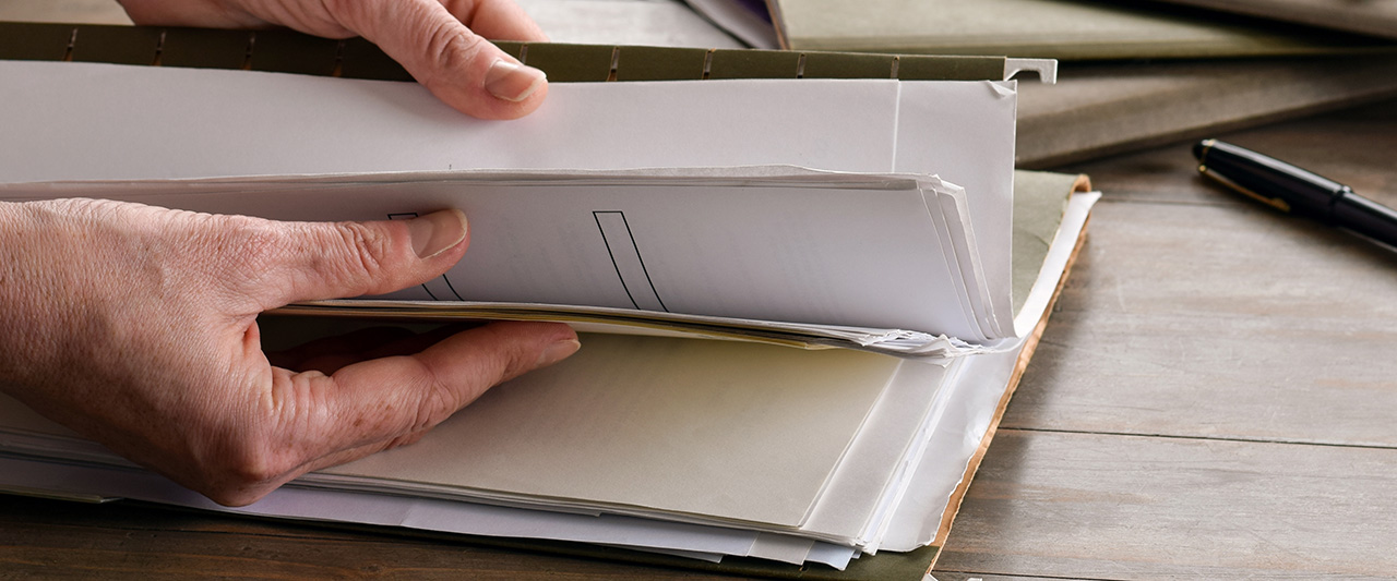 A person browses through a physical document