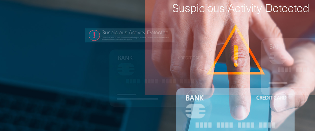 A decorative image showing a male hand reporting suspicious activity with a mobile phone