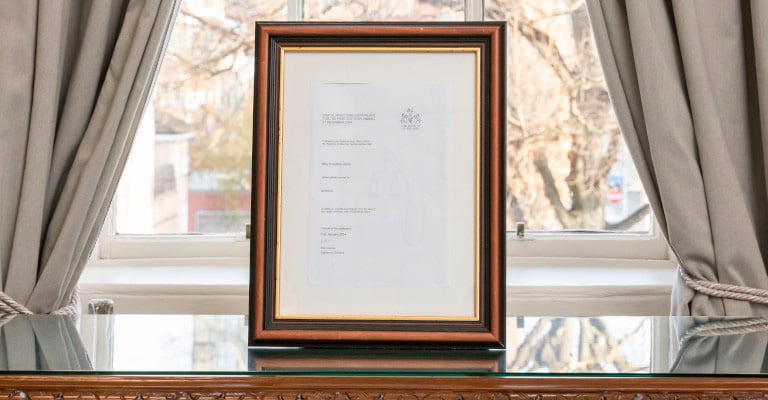 A practising certificate sitting on a solicitors' desk