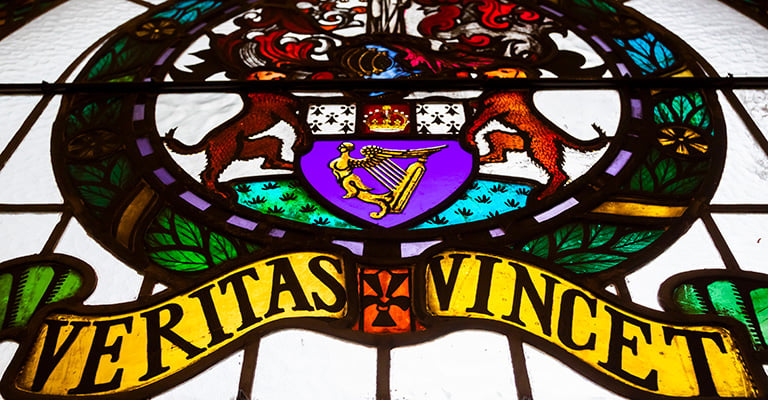 A window at blackhall place with the Law Society logo saying 'veritas vincet - the truth will triumph'