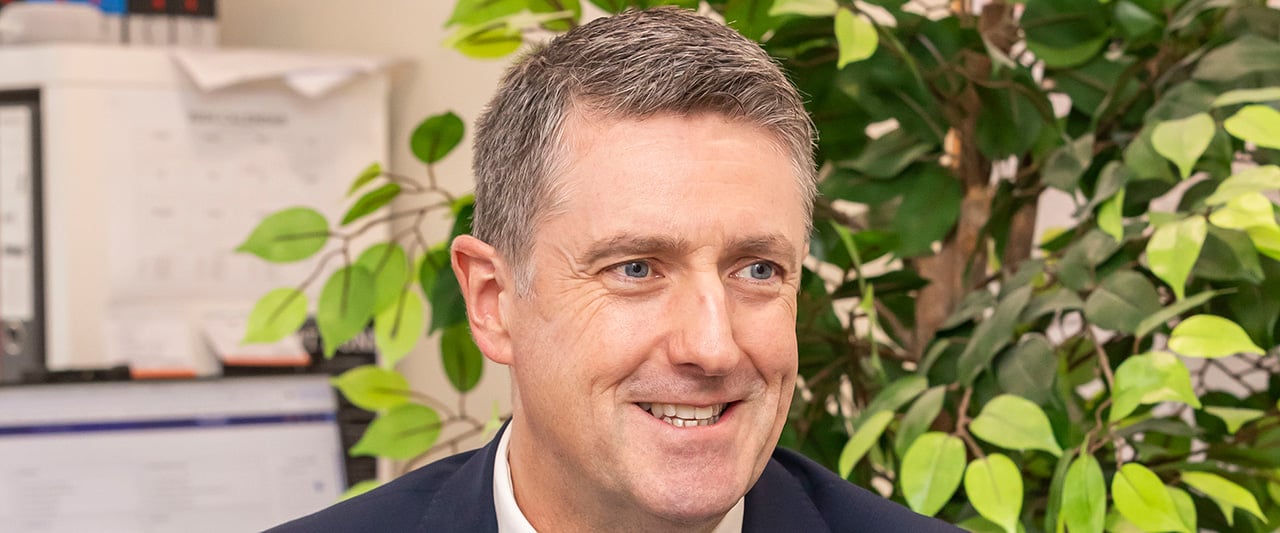 A close up shot of a male solicitor smiling